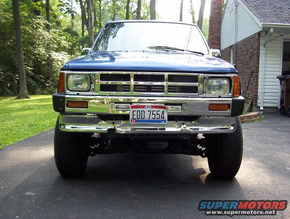 Blue Toyota pickup truck front view, chrome bumper, license plate EDD 7554