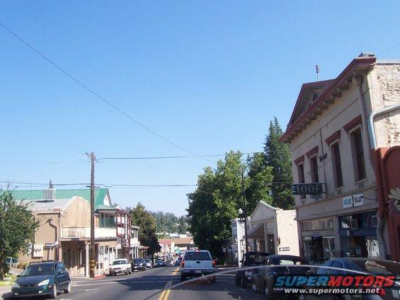 Street view of buildings and cars on a sunny day