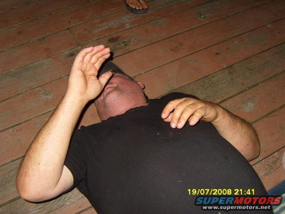 Man lying on wooden deck, date stamp 19/07/2008