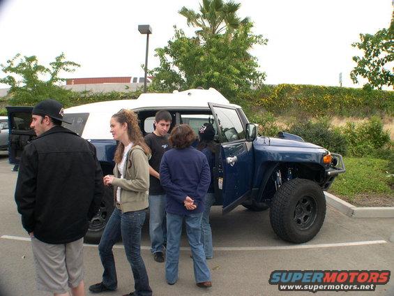 Blue 2007 Toyota FJ Cruiser with white roof, front passenger door open, parked in a lot