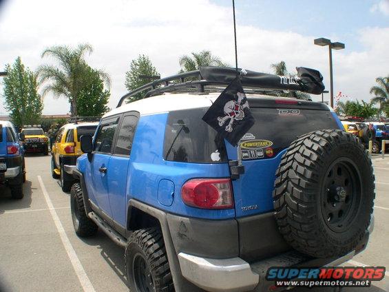 Blue 2007 Toyota FJ Cruiser with pirate flag and spare tire on rear