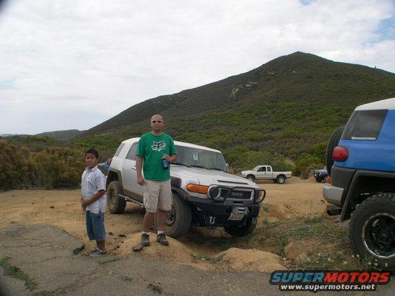 Silver Toyota FJ Cruiser with aftermarket bumper and winch parked on dirt road