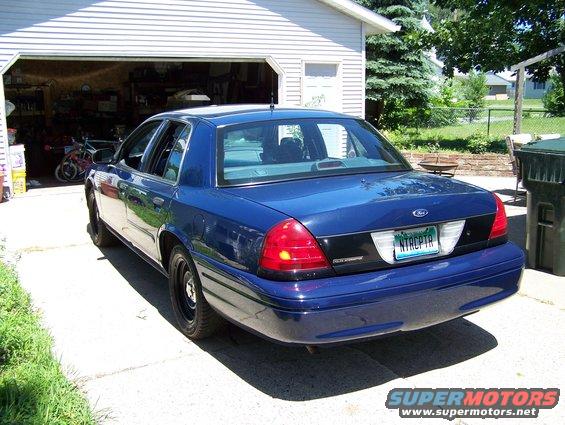 Blue 2002 Ford Crown Victoria parked in driveway, rear view