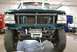 1996 Ford Bronco - The front of a teal Ford F-Series truck is shown with the grille removed, revealing the radiator and a winch.