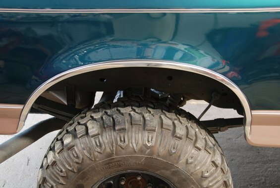 Close-up of a 1996 Ford Bronco's rear wheel well and tire