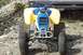 1989 Ford Bronco II - This ATV features a blue front grille and yellow body panels, with a silver bumper and knobby tires.