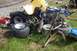 1989 Ford Bronco II - A yellow ATV is in pieces on the grass, with various parts scattered around it.