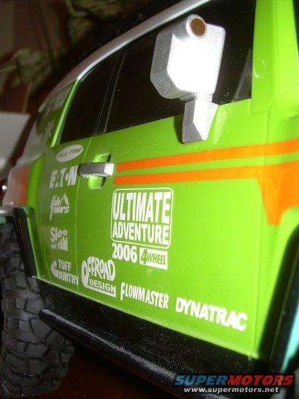 Green SUV side view with 'Ultimate Adventure 2006 4Wheel' decal
