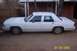 1991 Ford Crown Victoria LTD - This white sedan's body style suggests a model year in the 1980s, not 1991.
