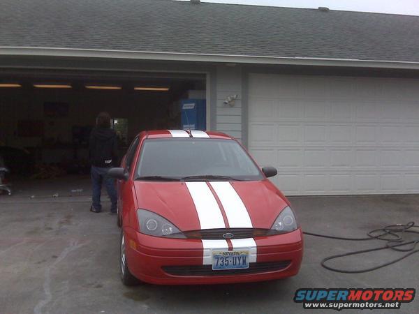 Red 2001 Ford Focus with white racing stripes and Nevada plates