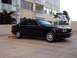 1994 BMW 5 Series - This black 1994 BMW 5 Series sedan is captured from a three-quarter front view in a parking lot setting.
