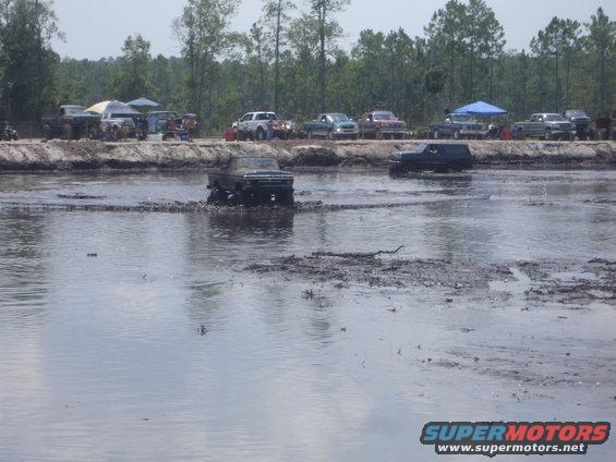 1989 Ford Bronco driving through mud