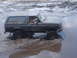 1989 Ford Bronco - 1989 Ford Bronco navigating a muddy off-road course.