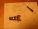 1992 Ford Bronco - Ignition lock cylinder and a small screwdriver are laid out on a paper towel with cartoon drawings.