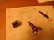 1992 Ford Bronco - Disassembled car ignition lock cylinder and key tumbler components laid out on a paper towel.