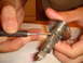 1992 Ford Bronco - A close-up shows a screwdriver being used to manipulate a car's ignition lock cylinder.
