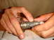 1992 Ford Bronco - Hands manipulate a car's ignition lock cylinder and key.