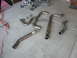 1996 Ford Probe - Several exhaust system components are visible on the ground, including pipes and gaskets.