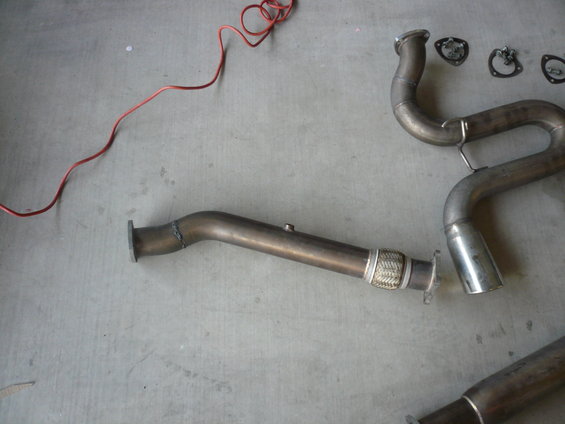 Exhaust system pipes and gaskets on a concrete floor