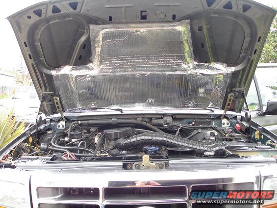 1994 Ford Bronco engine bay with hood open, showing engine and sound deadening material on hood
