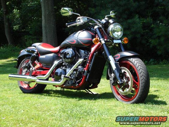 Motorcycle with flame decals and red accents, parked on grass. Engine reads '1800'