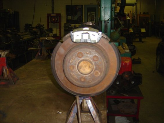 Rear brake rotor and caliper assembly on a stand
