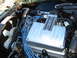 1973 Ford Ranchero - Close-up view of an engine bay, showing a metal cover and blue hoses.