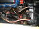 1978 Ford Ranchero - Close-up view of the engine bay, showing the battery, starter solenoid, and various electrical connections.