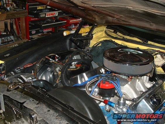 Engine bay with V8 engine, chrome air cleaner, and red distributor cap
