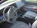 2003 Ford Crown Victoria - The interior of a 2003 Ford Crown Victoria features a gray dashboard, steering wheel, and cloth seats, along with an aftermarket center con…