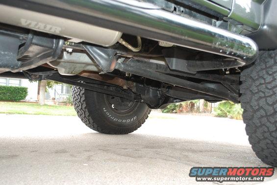 Undercarriage of a vehicle with a VIAIR muffler, BFGoodrich tires, and a black side step