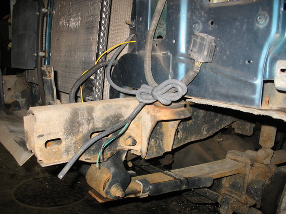 Front frame, leaf spring, and wiring harness of a vehicle