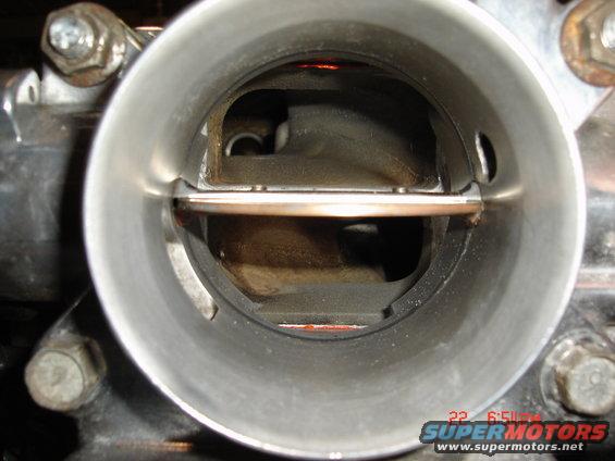 Inside view of a throttle body with the butterfly valve visible. There's a timestamp in the corner reading 22 6:51