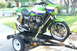 1981 Kawasaki Bayou - A sport motorcycle is secured to a trailer with yellow straps, ready for transport.