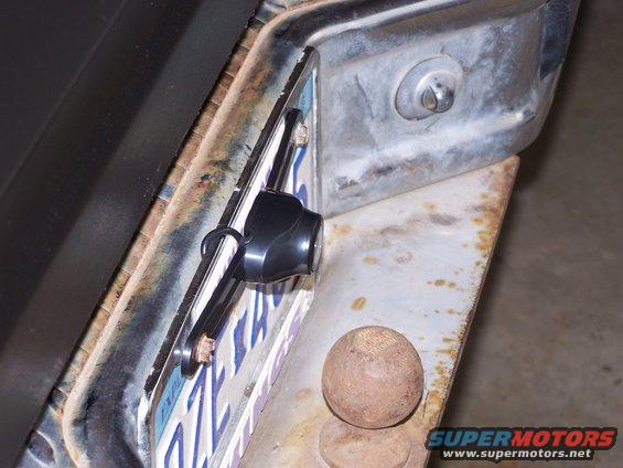 Backup camera attached to license plate bracket on a vehicle's rear bumper