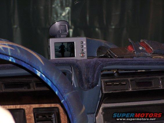 1986 Ford Bronco interior showing dashboard with a backup camera display and suction cup mount