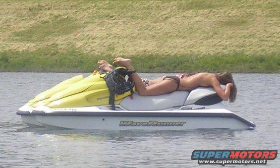 Person sunbathing on a WaveRunner jet ski in the water