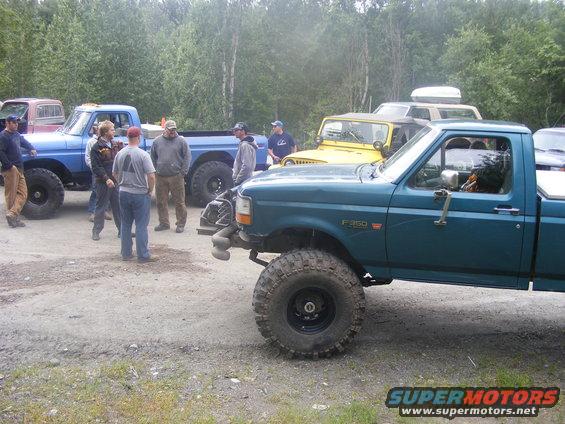 Teal pickup truck with large tires and F-350 badging