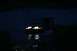1990 Chevrolet Suburban - A vehicle navigates through dark water at night, its headlights illuminating the path ahead.