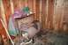 1990 Chevrolet Suburban - The interior of a cabin shows a makeshift wood stove and blankets draped over a shelf.