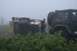 1990 Chevrolet Suburban - A person attempts to right an overturned trailer with the assistance of a Jeep in a foggy, overgrown area.