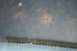 1990 Chevrolet Suburban - A blurry reflection of trees and sky appears on a window, with a building visible below.