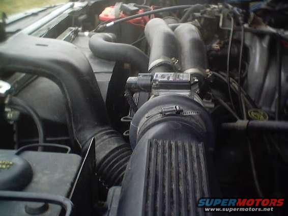 engine bay with intake hoses, air filter housing, and some wiring visible