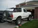 1992 Ford Bronco - This 1992 Ford Bronco is seen from a three-quarter front angle, parked in front of a brick house.