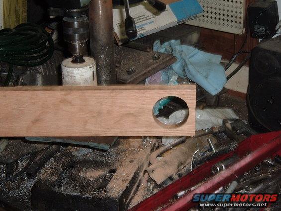 tbspacer-005.jpg First use the hole saw to cut a hole in a piece of hard wood so that the hole saw won't wander around when it begins to cut into the aluminum.