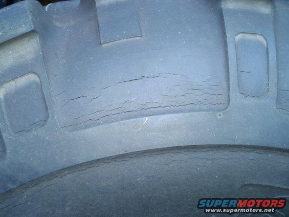 Close-up of a tire tread showing significant cracking