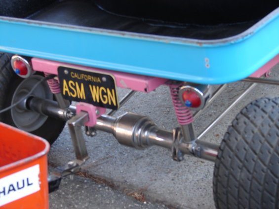 Custom vehicle rear axle with pink suspension and California license plate ASM WGN