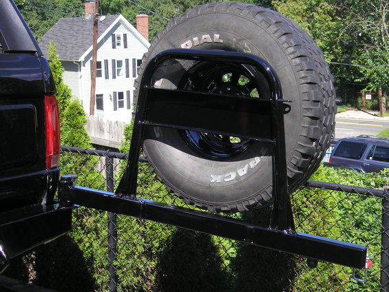 Black rear bumper with spare tire carrier and tire