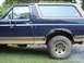 1989 Ford Bronco - Side view of a 1989 Ford Bronco with visible rust on the rear wheel arch.