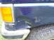 1989 Ford Bronco - This dark blue SUV shows significant damage to its rear quarter panel and bumper.